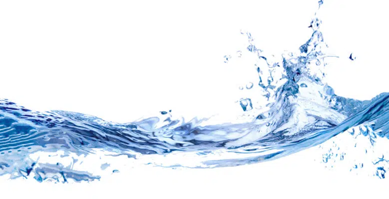 A dynamic splash of water against a white background, capturing the movement and fluidity of the liquid. The water appears clear, with visible waves and droplets suspended in the air, showcasing a sense of freshness and energy, reminiscent of the pristine results seen in advanced domestic wastewater systems.